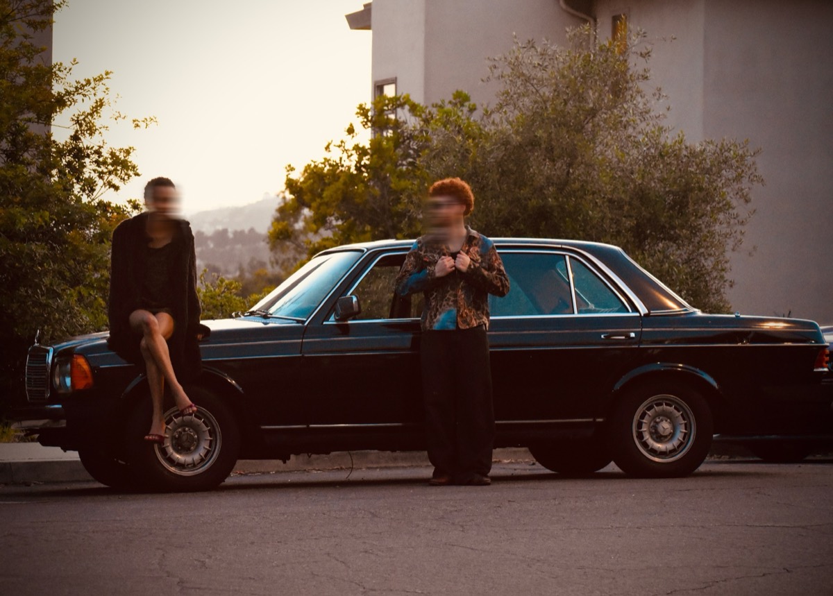 Golden hour, the couple and the black Mercedes
